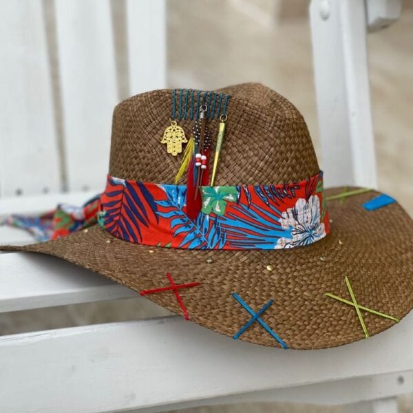 a brown hat with colorful ribbon and a red and blue flower design