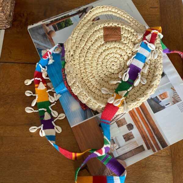 Bolso redondo tejido a mano con correa en telar guatemalteco y decoración de caracoles cauri – cartera cruzada artesanal colombiana única, estilo étnico artesanal, ideal para días de playa en verano, festivales al aire libre, vacaciones y outfits casuales. Milolita handwoven round boho bag with Guatemalan loom strap and cowrie shell decoration – unique Colombian handmade crossbody purse, artisan ethnic style, perfect for summer beach days, outdoor festivals, vacations, and casual outfits., Folky Shell & Tassel Bag, sombreros de palma de iraca, sombreros decorados en colombia, sombreros personalizados de palma de iraca, sombreros artesanales con bordados, Hats made of Iraca palm